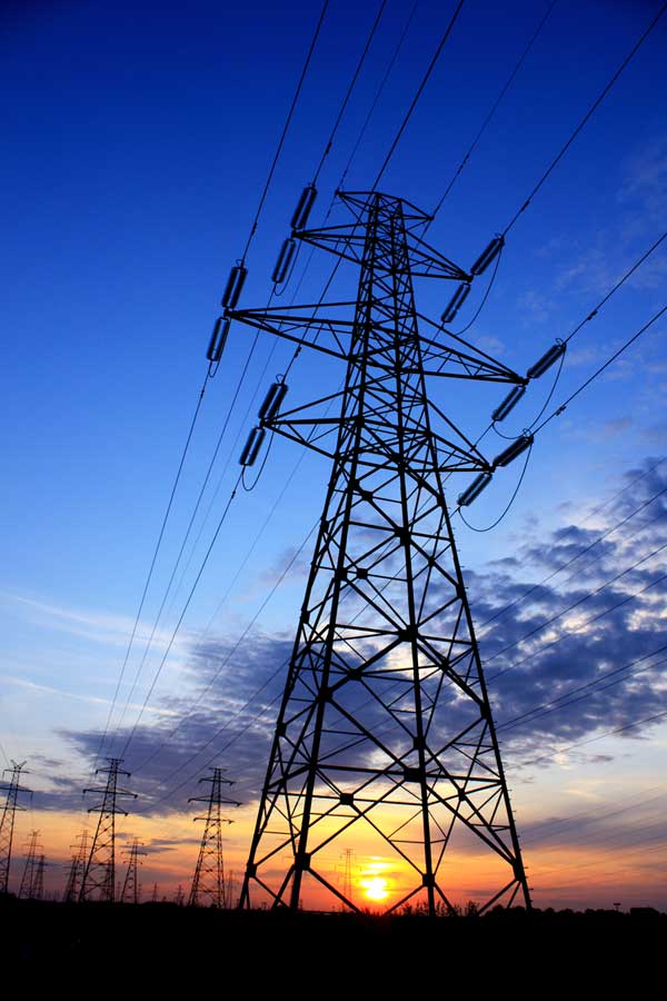 Image of a high voltage tower at sunset