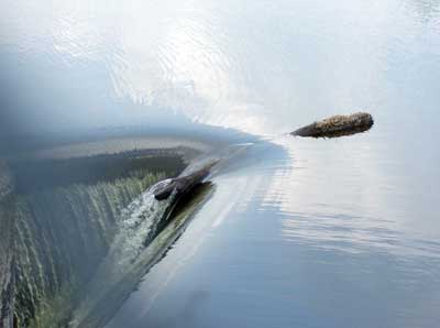 Image of water flowing over control edge